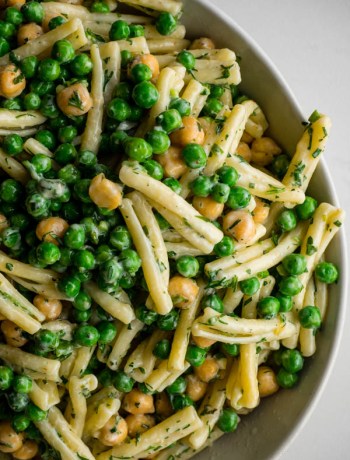 Overhead close up of green goddess pasta salad with peas, chickpeas and herb dressing.